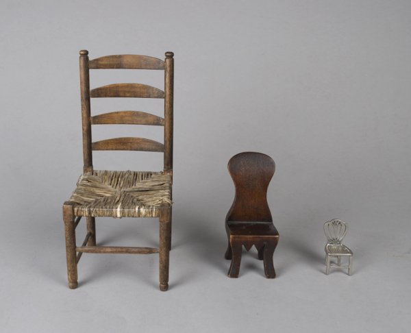 ( 3 ) Fine Miniature Chairs,: Rush seat ladder back chair circa 1940 10" H, slight loss to rush seat, a carved pine balloon back chair. 5 1/4" H, light surface abrasion to seat and a Kirkstieff pewter chair with open splat, 2 1/4"