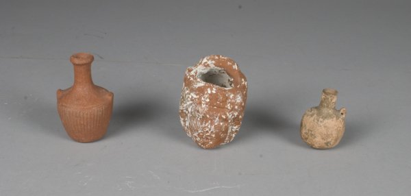 (3) Small Pottery Jugs, Old Kingdom: One two-sided depicting ladies face with central handle, heavy calcification, 3.25" H. One jug with incised decoration on body and two nub handles, fully intact with much of its' original glaze, 3.25"
