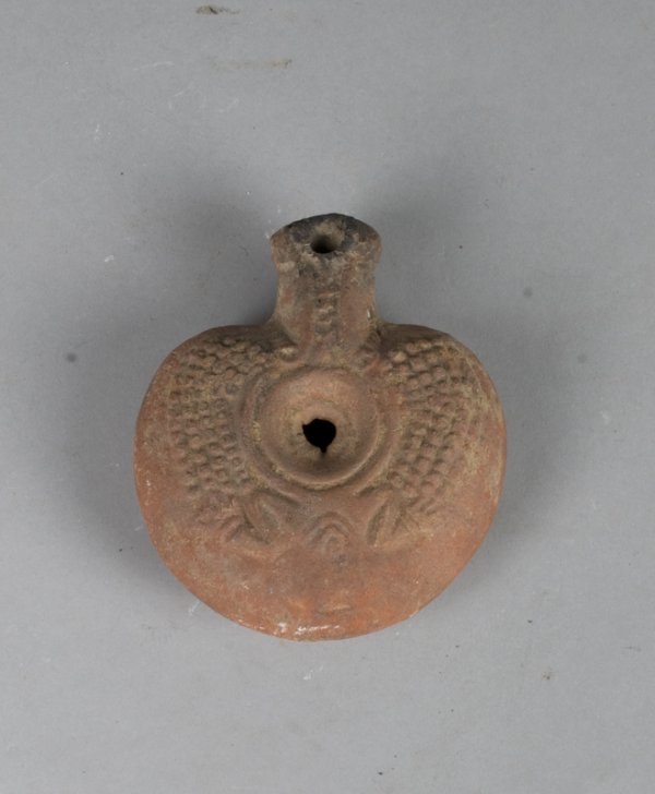 Egyptian Frog Lamp, Probably 3rd-4th C. BC: Of lentoid shape with flattened base, central filling hole with sloping walls, high relief stylized frog on shoulders. 4.25" L. Totally intact and a superb example of this popular and original lamp. A