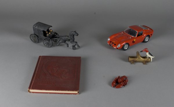5 Vintage Cast Iron & OtherToy Items: Includes a cast iron horse and buggy toy, a cast iron lobster, a cast iron woodpecker, a Ferrari car and a book titled "Book Trails on the Highroad to Adventure." All in good condition. Private collec