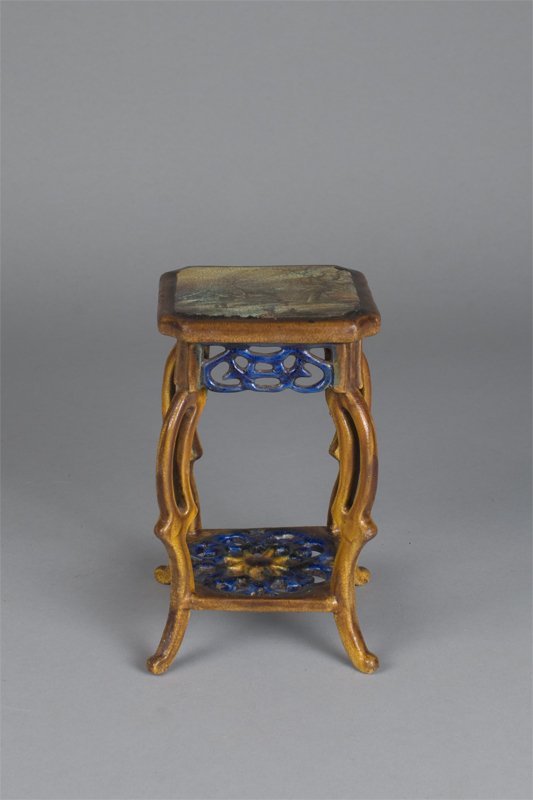 A Fine And Rare Majolica Stand Circa 1880: Molded to depict a french work table with canted corners, openwork undertier, and french feet.The top depicting a winter scene with children playing outside a chalet, the balance decorated in vibrant 