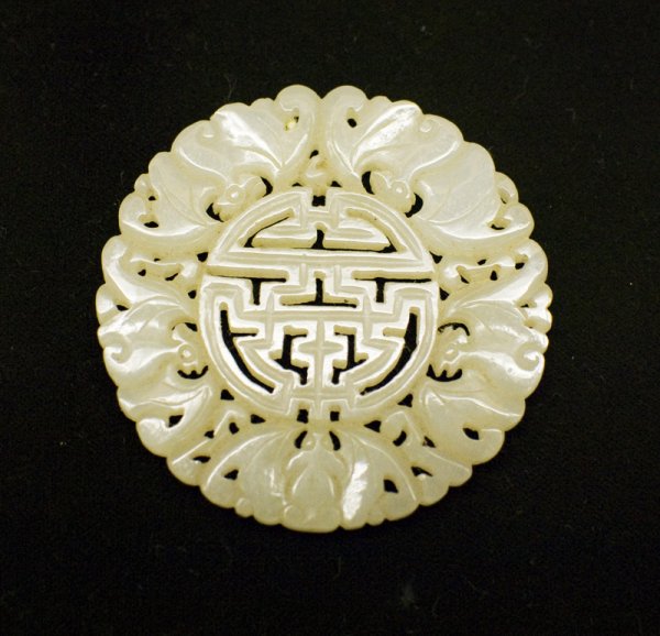 Chinese Qing Carved Jade Plaque: Carved to depict a shou symbol surrounded by 4 bats in profile and one bat facing straight on. 2.125"D, 18th C. Provenance: Duk Soo Palace, Seoul Korea 1951. Estate of Lionel Hayes, a sargent in the 1