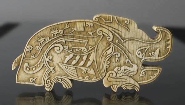 A Large Chinese Qing Carved Ivory Scroll Weight: The large thick ivory carved to depict a mythical horned beast or boar with finley carved details. 5.5"L x 2.5"H x .5" Thick, Circa 18th C. Provenance: Duk Soo Palace, Seoul Korea 1951. Estate of Lion