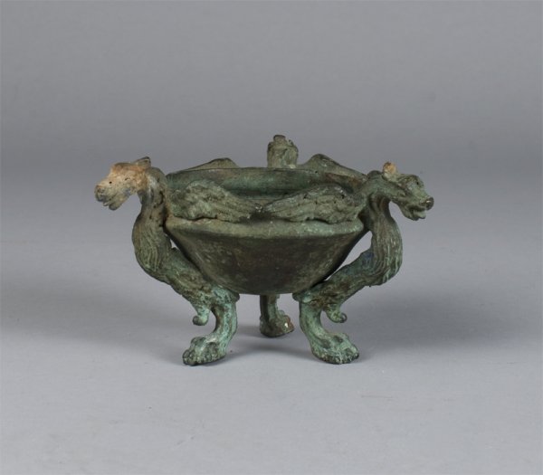 A Chinese Antique Shang Style Bronze Censor: The bronze bowl mounted on three winged beast supports with paw feet and dragon heads.3"H x4"D, 1.5lbs, nice surface. 18th Century or earlier. Provenance: Duk Soo Palace, Seoul Korea 1951. Estate of L