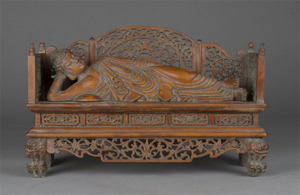 Chinese Boxwood (Huang Yang Mu) of a Buddha: Chinese boxwood (huang yang mu), 19th C. carving of a reclining Buddha attaining Parinirvana. Pillow under right arm, holding head up, lying with draped folds of robe. Resting on settee with tendril p