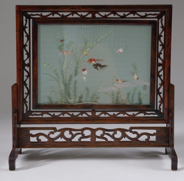 19th/Early 20th C. Chinese Rosewood and Silk Panel: Silk panel with several fantail fish swimming amongst seaweed, signed. Areas of losses not affecting more than 10% of entire silk. Mounted in a carved rosewood stand. Panel on swivel. Very nice qualit