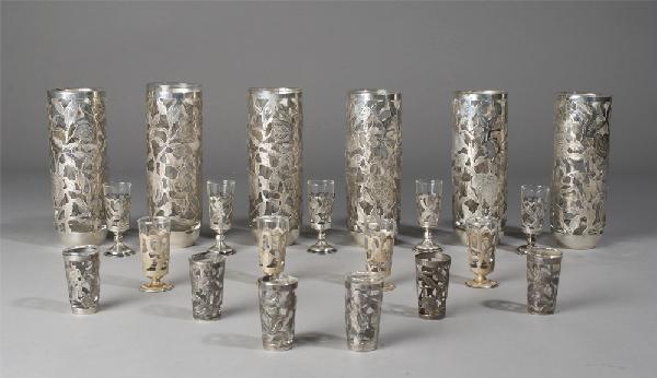 Collection of 21 Mexican Sterling Overlay Glasses: Includes 6 drinking glasses, 7" H, stamped JGE and Eddie's, approximately 2 ounces each. 5 footed cordial glasses, 3.25" H (one foot bent), approximately 7 grams each. 4 smaller footed cordial glasses