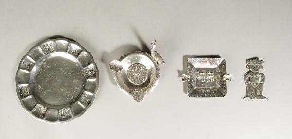 4 Unique Mexican Sterling Articles: Includes a .800 Aztec figure pin, 2 & 7/8" L. A .925 small ashtray with camels, 3.5" L. A .925 ashtray with coins and camel handle, 4" L. And a .925 scalloped edge plate decorated with animal and flor