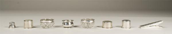 Collection of 8 Sterling Articles: Includes four Sterling bottle caps, various sizes, a Sterling salt dip, two cut glass and Sterling salt dips, and a Sterling clothes pin. 182 grams TW.