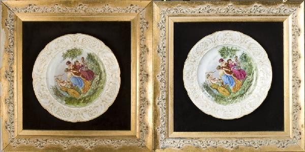 (2) Porcelain KPM Plates, set in Frame: Plates decorated with three ladies pulling a rickshaw with an angel riding, with enameled highlights. Edge decorated in gilt scrolling designs with pink enamel highlights. Plates measures 9.75" Dia.,