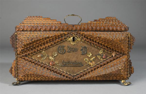 Very Fine Antique Tramp Art Jewelry Box: Box decorated with mustard yellow fabric. Front, back and top with applied floral decorations. Front with applied G Zuin D Andenken, back with applied 1900 E Q, and top with pull. Sides with lion head