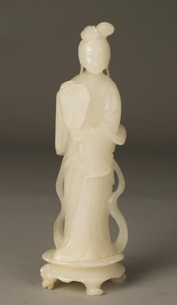 Chinese Carved Soapstone Geisha: Well done carving of a geisha on base, holding a fan with sash extending to ground. 9" H, chip on base, restoration to one base foot and chip to another base foot.