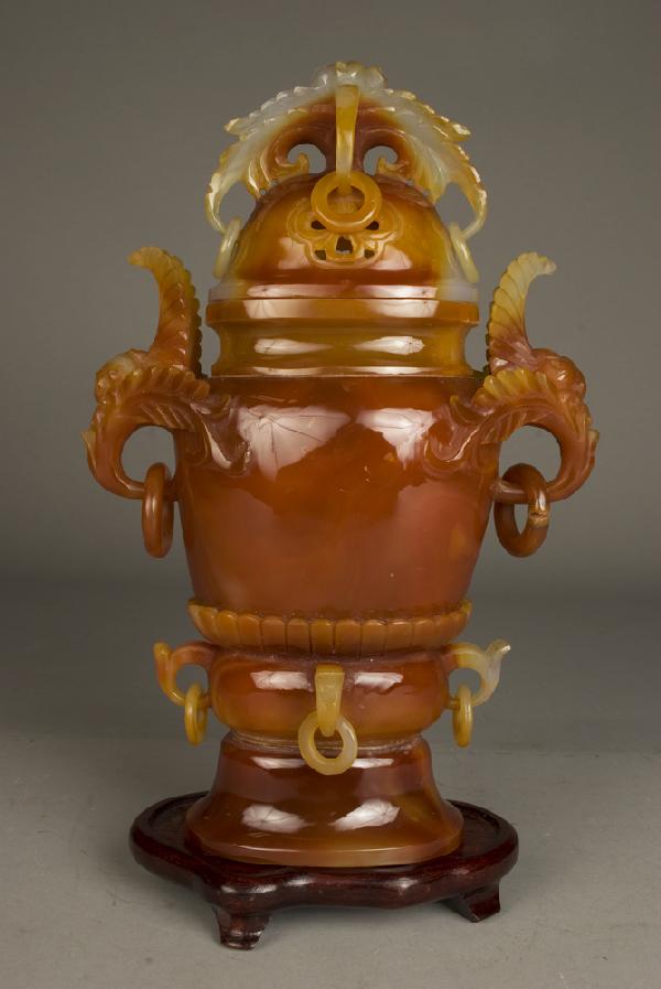 Fine Chinese Qing Carved Red Agate Urn: Finley carved Mongolian Red Agate urn with many rings carved into all the handles. Top handles with floral and feather carvings, and lid with feather and floral carvings, with two cut-out symbol. Larg