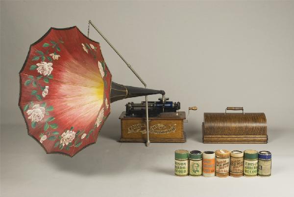 Early 20th C. Edison Home Phonograph: Model A, "suitcase" phonograph. Oak cabinet with finger joints, serial #H153626, decaled front and with painted flower horn. Includes 7 playable cylinders. Private collection Oxford, Michigan.