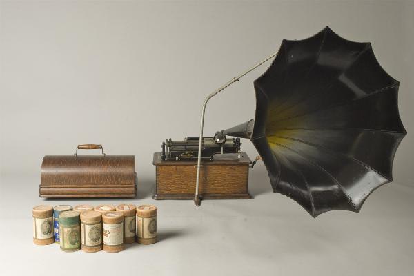 Early 20th C. Edison Home Phonograph: Model A, "suitcase" phonograph. Oak cabinet with finger joints, serial #312207, decaled front and with flower horn. Includes 8 playable cylinders. Private collection Oxford, Michigan.