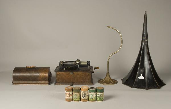 Early 20th C. Edison Home Phonograph: Model A (?), phonograph. Oak cabinet with finger joints, serial #336616, decaled front. Includes flower horn, horn support, lid and 5 playable cylinders. Private collection Oxford, Michigan.