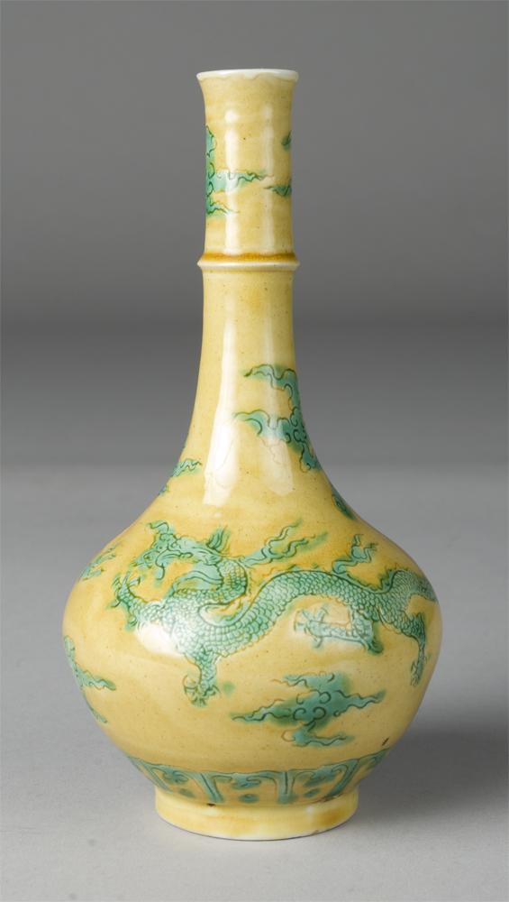 Rare Chinese Green And Yellow Dragon Vase: A fine Chinese Qing green and yellow enameled incised dragon vase, the bottle shaped vase with long slender neck, with central ring, the exterior well carved and decorated with green enamel to depict