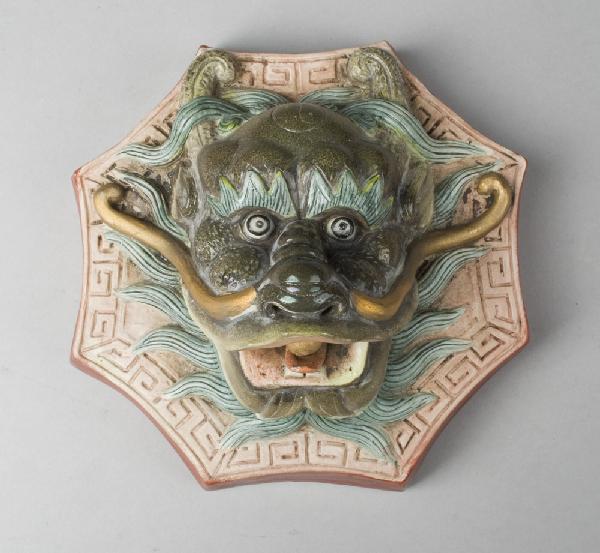 Chinese Famille Verte Three Dimensional Plaque: Finley molded to depict a fierce dragon with open mouth, it's tung clasping a pearl, nine character impressed mark within a square on the unglazed back, shaped and reinforced hanger. 7"H x 7"W x 4"D,