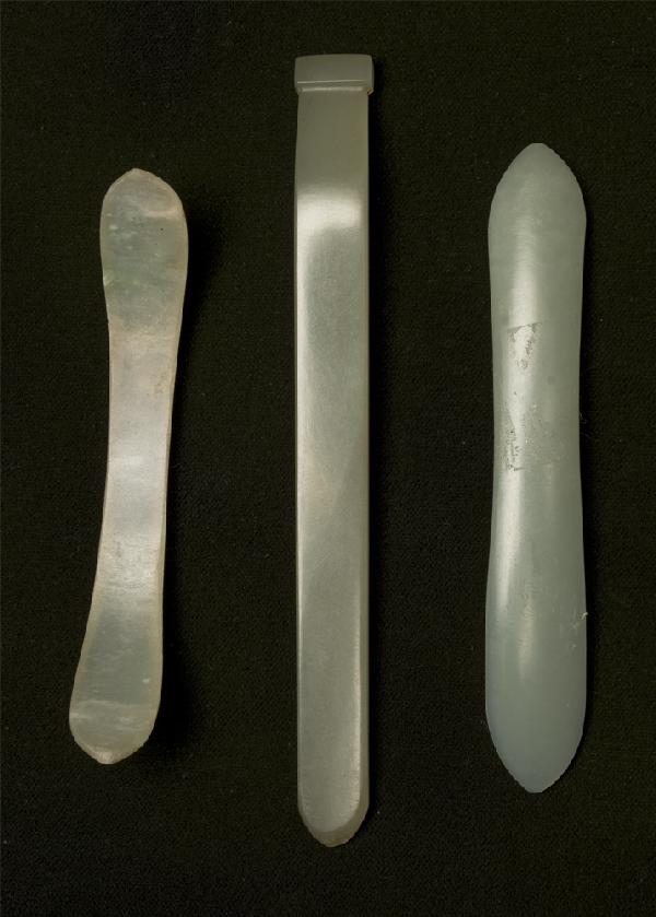 (3) Chinese Qing Carved Jade Hair Pins: First in celadon jade, pin straight carved with pointed end and divot on top, 4.25" L. Second jadeite, pin carved canoe shape, 3" L. And third celadon jade, pin carved with pointed ends, one slightly 