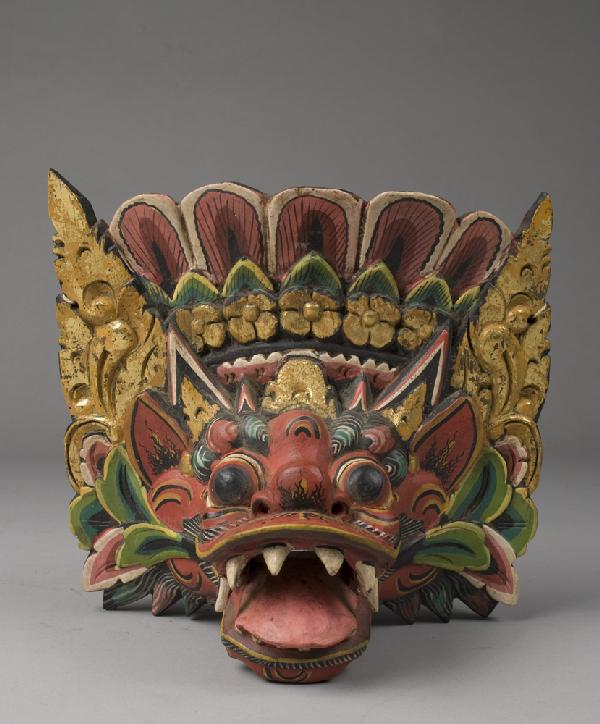 Balinese Demon Wooden Hanging Mask: Carved wood and painted to depict Balinese Demon in vibrant colors, and with hanger in back. 9.5" H x 9.5" W. 20th Century.