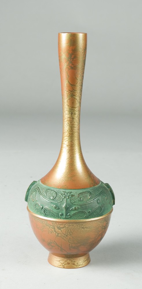 Unique Japanese Brass Vase: Decorated in orange and gold marble with central raised design in green of two bats, with two small handles. 9.5" H. 20th Century.