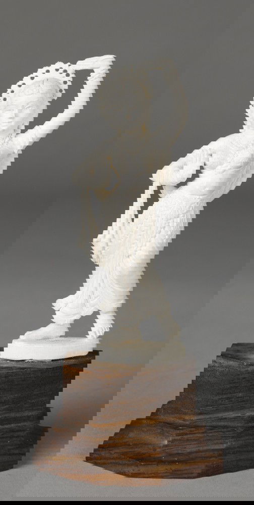 Fine Carved Indian Ivory Goddess: Finely carved to depict a goddess with hands positioned and halo, mounted on a sectional wood carved plinth. 5.5" H, circa early 20th Century.