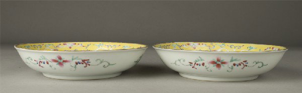 Pr. Chinese Famille Rose Porcelain Shallow Bowls: The bowls with a yellow ground, the sides painted with lotus flowers and antiques, the center with a shou symbol, surrounded by bats, the exterior white with three cartouches of flowers, each bears th