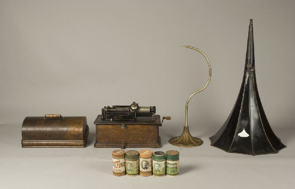 Early 20th C. Edison Home Phonograph: Model A (?), phonograph. Oak cabinet with finger joints, serial #336616, decaled front. Includes flower horn, horn support, lid and 5 playable cylinders. Private collection Oxford, Michigan.