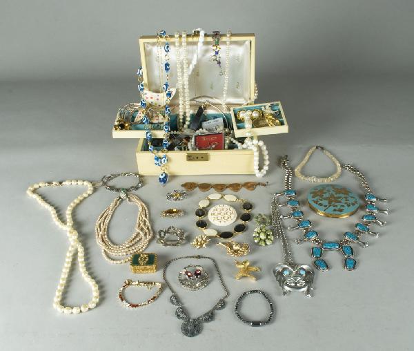 Large Lot Of Oer 100 Pieces Of Costume Jewelry: Including, brooches, neckpieces, native American, enamel pill box, and more, together with a 1950's jewelry box and key, a very nice lot.