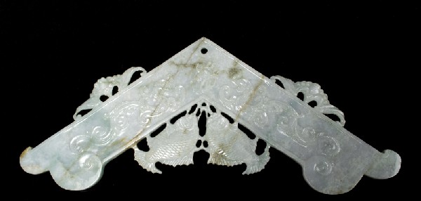 Large Chinese Carved Jade Bell: Finely carved on both sides in the archaic form to depict two dragons chasing a flaming pearl surmounted by two carp. The top with stylized bats. 14.25" W x 7" H. Circa 20th Century.