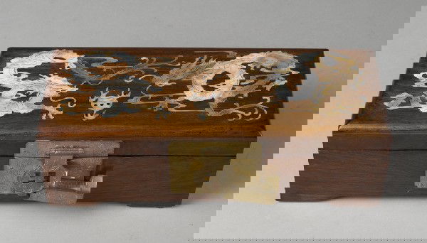 Fine Chinese Rosewood & M.O.P. Jewelry Box: Rectangular box with fine inlay of Mother-of-Pearl on top of lid depicting two dragons chasing a flaming pearl. Interior lined with red and white silk, contains two ring holders and center box. Brass