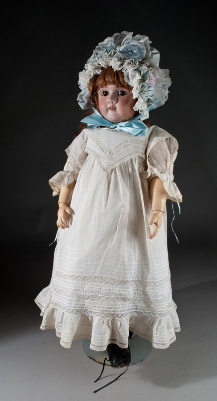 Heinrich Hanwerck Porcelain Doll: Head marked Hanwerck 109 13 & 1/2 X 6 & 1/2. Jointed composition body, human hair wig, small crack old clothes, brown glass rocker eyes and open mouth. Head 15.25" Dia., body size 25" L, doll height 3