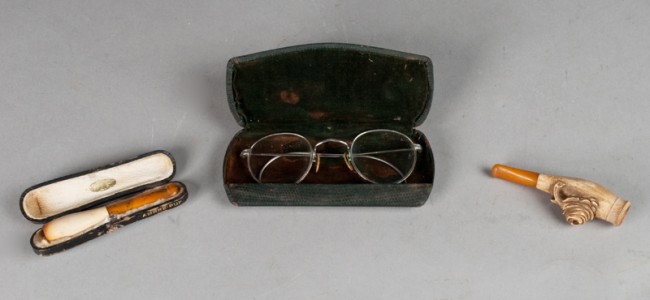 Gentleman's (3) Piece Smoking & Reading Lot: Includes a Ecume Veritable cigarette holder with case, a cigar holder with floral decoration, and a pair of cased 12K white gold rimmed glasses. All with wear consistent with age and use.