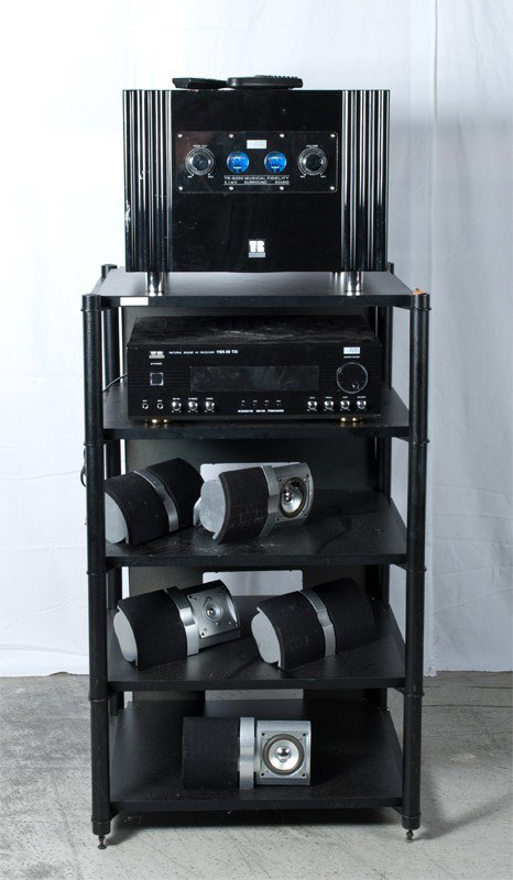 (8) Piece Surround Sound Unit: Includes rack for display, AV receiver, and surround sound with five speakers. Unknown working condition.