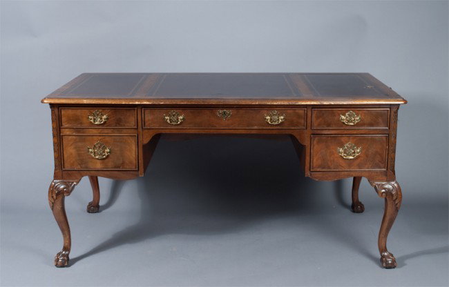 Fine King George Style Desk: Made by Sligh Furniture in Holland, Michigan. Three piece wood framed dark brown leather top with antique gold colored tooling. Central drawer with two right hand box drawers and one left hand letter/