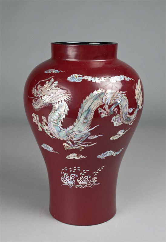 Large Lacquered Korean and Abalone Inlaid Vase: Burgundy lacquer with black interior, inlaid with dragon motif amid clouds in abalone. 14.5" H x 10.25" W. Very good condition.