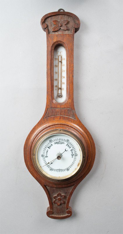 Antique Oak Barometer: Banjo form with thermometer on top and barometer on bottom. Carved oak case with floral decorations. 19" L.