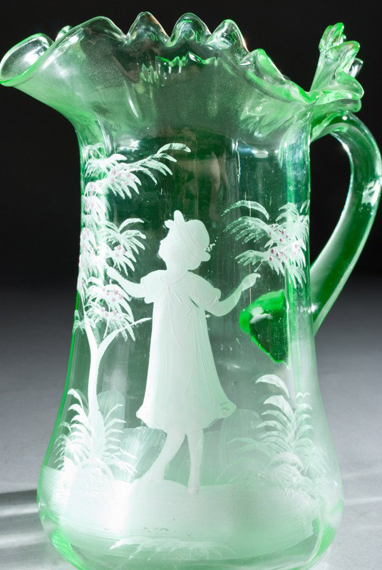 Mary Gregory Style Enameled Pitcher: Painted to depict a little girl between two trees, in green glass, 8.75"H.