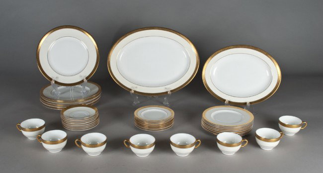 (42) Pieces Fine Minton's Porcelain: In the Buckingham pattern, includes cups, saucers, dinner plates, bread plates, two large platters, and others.