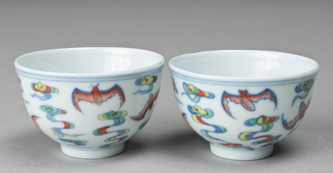 Pr. Of Chinese Famille Rose Porcelain Wine Cups: Each footed cup decorated with flying bats amid ruyi. 1.5" H x 2 & 3/8" Dia. Four character mark in underglaze blue within two squares on underside.