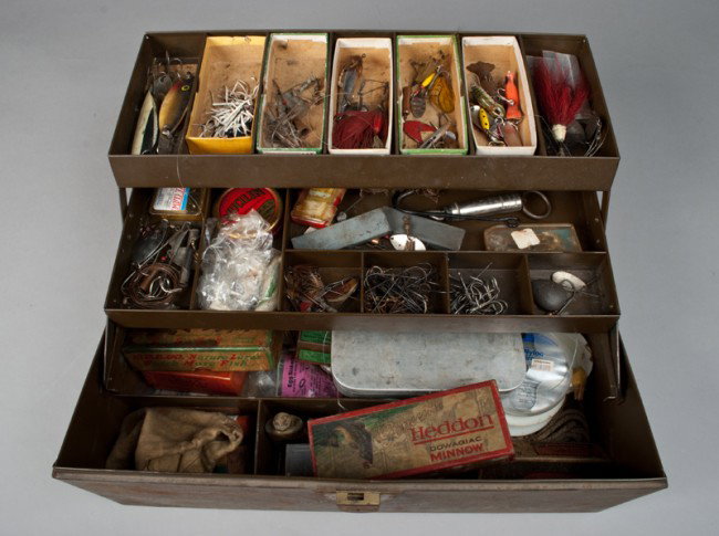 Antique Tackle Box And Lures: Includes over 100 fishing lures, including boxed a heddon dowagiac minnow, a A. L. Foss pork rind minnow, a Lori Eppinger Osprey dardevle, a O.C. Tuttle devil bug, a small reel in felt bag and numerou