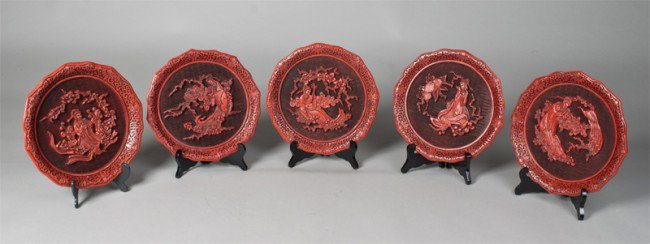 (5) Cinnabar Laquer Museum Oriental Plates: Carefully crafted of cinnabar or exotic Oriental lacquerware. To include "Five Perceptions of Weo Cho-Sight, Touch, Hearing, Smell and Taste." Each with original box and stands, lacking one stand. 9.7
