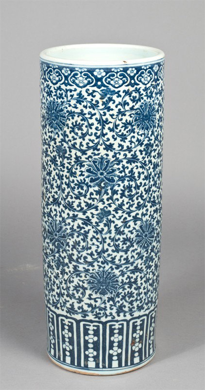 Chinese Blue & White Porcelain Umbrella Stand: Large umbrella stand decorated with floral and scrolling vine designs and patterned panels at base. 24.5" H, underside with cracks, numerous glaze anomoles throughout.