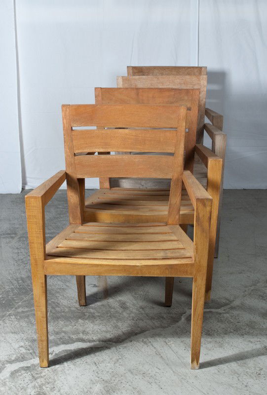 (4) Teakwood Outdoor Chairs: Four teak chairs, two are stained, other two are weathered. 33.5" H x 24.5" W x 20.75" D.