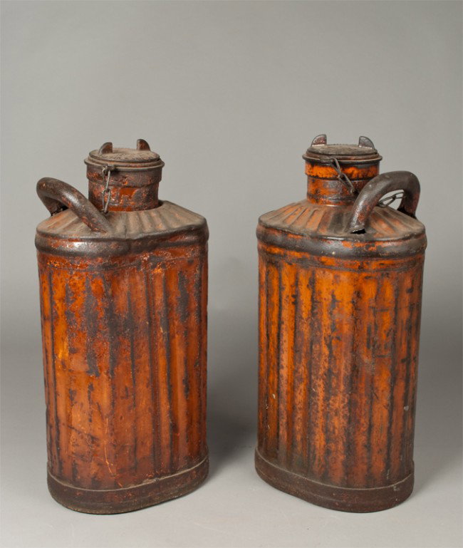 Pr. Of Antique Gas Cans: Lidded gas cans with single handle and painted orange, made by The Davis Welding & MFG Co. Cincinnati, OH. 23" H x 1.5" W. Some denting and wear to paint.