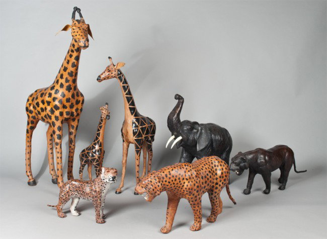 (7) Leather and Wood African Game Animals: To include three giraffes, three leopards and one elephant, all with realistic details. Tallest 37" H.