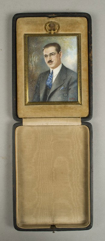 Miniature Portrait on Ivory of a Gentleman: Exceptionally painted in watercolor, this Early 20th C. portrait is signed Docken. Comes encased in its own frame under bubble glass and is displayed in its own custom fit locket box. Measures 4.5" L 