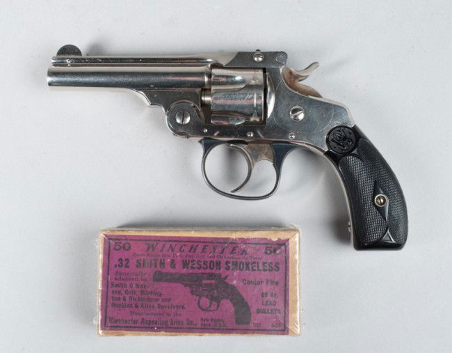 Exceptional Smith & Wesson 32 Cal Circa 1890: Serial no. 200320, 32 cal, 4" barrel, nickle plated, gutta percha grips, case colored hammer, and trigger, with original picture box of ammo with 27 rounds. Gun is mint condition and appears to have b