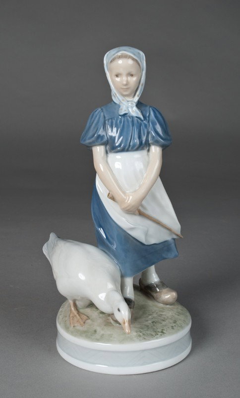 Royal Copenhagen "Girl with Goose" Figurine: #527 depicting a young girl with a large white goose to her right. Artist mark CThr, for Christopher Thompson left of her shoe. 9.5" H, and in excellent condition.