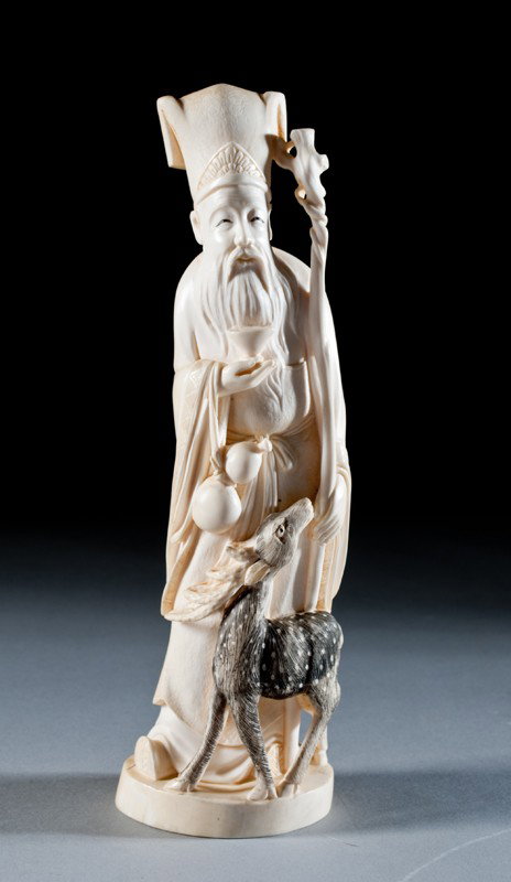 A Fine Chinese Qing Ivory Carving: Finely carved to depict an elder holding his staff, a wine cup and a double gourd vase, with deer at his feet, and ink highlights. The base with three character mark within a red square. 9" H, circa 1